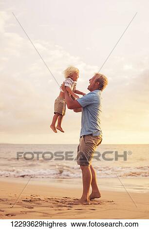 Stock Photograph - Father and son playing at sunset. Fotosearch