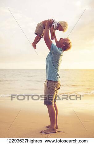 Stock Photograph - Father and son playing at sunset. Fotosearch