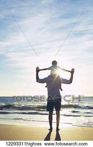 Father and Son Playing on the Beach at Sunset View Large Photo Image Stock Photograph - Father and Son Playing on the Beach at Sunset. Fotosearch
