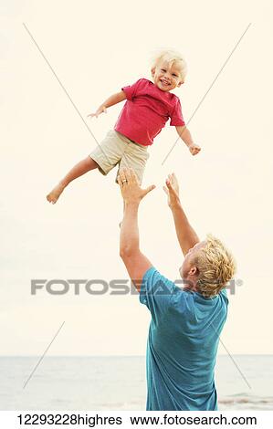 Father and son playing together View Large Photo Image Stock Photograph - Father and son playing together. Fotosearch