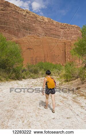 Female adventurer exploring a desert canyon narrows, Capitol Reef National Park; Utah, United States of America View Large Photo Image Stock Image - Female adventurer exploring a desert canyon narrows, Capitol Reef National Park; Utah, United States of America. Fotosearch