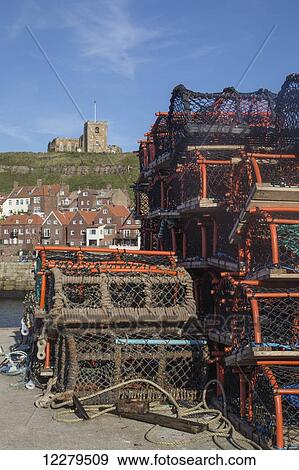 Stock Photo - Fishing traps on the shore in the harbour; Whitby, North Yorkshire, England. Fotosearch