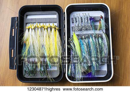 Stock Photograph - Flies tied meticulously by an avid fisherman for lake trout fishing; Chilliwack, British Columbia, Canada. Fotosearch