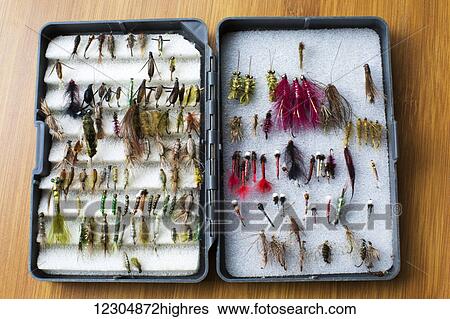 Stock Photograph - Flies tied meticulously by an avid fisherman for lake trout fishing; Chilliwack, British Columbia, Canada. Fotosearch