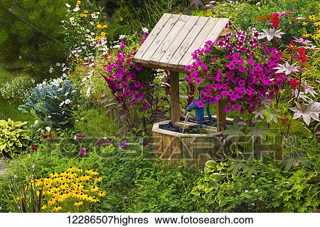 Flowers in a garden with a wishing well; Granby, Quebec, Canada View Large Photo Image Stock Photograph - Flowers in a garden with a wishing well; Granby, Quebec, Canada. Fotosearch