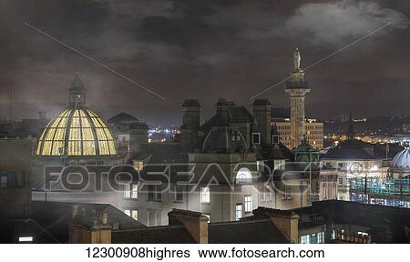 Stock Photograph - Fog sets in over buildings at nighttime; Newcastle, Northumberland, England. Fotosearch