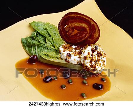 Stock Photograph - Food - Romaine Hearts Mediterranean. Ingredients include Romaine lettuce hearts, goat cheese, pancetta, walnuts, vegetable stock, sun-dried tomatoes, capers and Kalamata olives.. Fotosearch