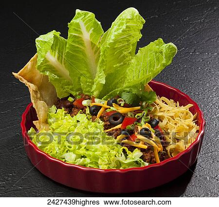Food - Romaine Mexican Fiesta Salad. Ingredients include Romaine lettuce, onion, garlic, ground beef, chili powder, cumin, tomato paste, red kidney beans, flour tortillas, tomatoes, sharp cheddar cheese, green onions (scallions), black olives, fried corn View Large Photo Image Stock Photograph - Food - Romaine Mexican Fiesta Salad. Ingredients include Romaine lettuce, onion, garlic, ground beef, chili powder, cumin, tomato paste, red kidney beans, flour tortillas, tomatoes, sharp cheddar cheese, green onions (scallions), black olives, fried corn. Fotosearch