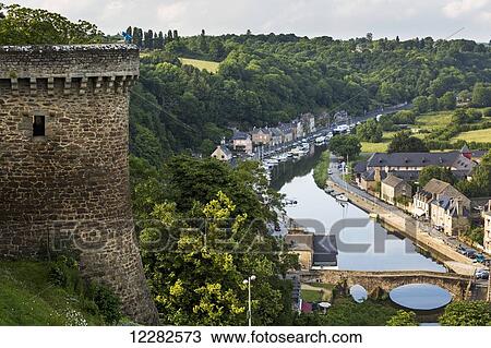Fortress stone wall turret overlooking riverside treed valley town with stone bridge; Dinan, Brittany, France View Large Photo Image Stock Image - Fortress stone wall turret overlooking riverside treed valley town with stone bridge; Dinan, Brittany, France. Fotosearch