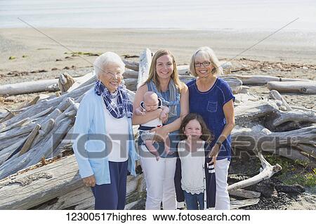 Stock Photograph - Four generations of women in a family posing on a beach; Fox Spit, Whidbey Island, Washington, United States of America. Fotosearch