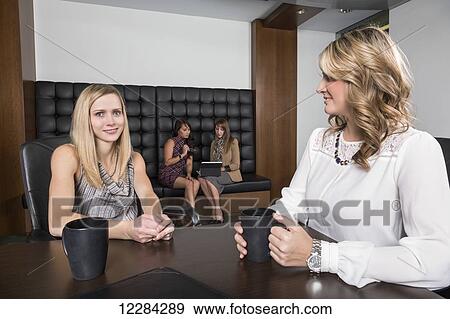 Four professional business women meeting in a boardroom; St. Albert, Alberta, Canada View Large Photo Image Stock Photo - Four professional business women meeting in a boardroom; St. Albert, Alberta, Canada. Fotosearch
