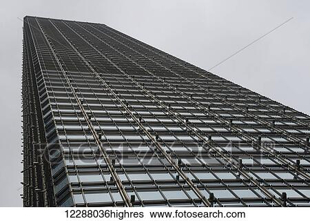 Stock Photograph - Geometric grid of windows on glass skyscraper; Hong Kong, China. Fotosearch