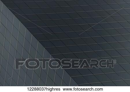 Stock Photograph - Geometric pattern of squares on grey skyscraper; Hong Kong, China. Fotosearch
