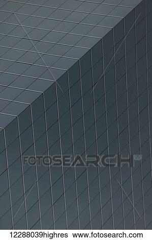 Stock Photograph - Geometric pattern of windows on grey skyscraper; Hong Kong, China. Fotosearch