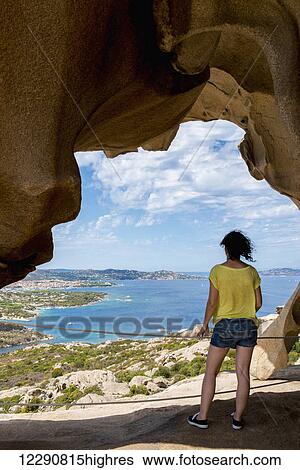 Stock Photograph - Girl enjoying the panoramic view from Capo d'Orso; Palau, Sardinia, Italy. Fotosearch