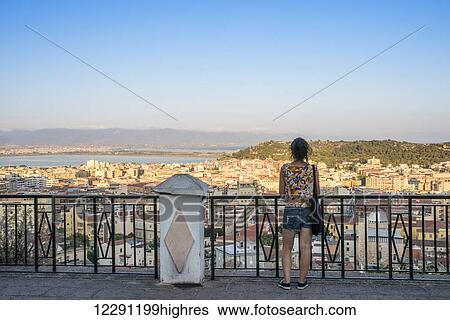 Girl enjoying the panoramic view of the city of Cagliari; Cagliari, Sardinia, Italy View Large Photo Image Stock Photograph - Girl enjoying the panoramic view of the city of Cagliari; Cagliari, Sardinia, Italy. Fotosearch