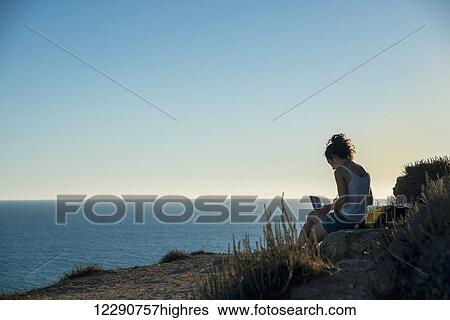 Girl painting at the water's edge; Tharros, Sardinia, Italy View Large Photo Image Stock Photograph - Girl painting at the water's edge; Tharros, Sardinia, Italy. Fotosearch