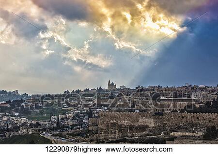 Stock Photograph - Golden clouds over the cityscape of Jerusalem; Jerusalem, Israel. Fotosearch