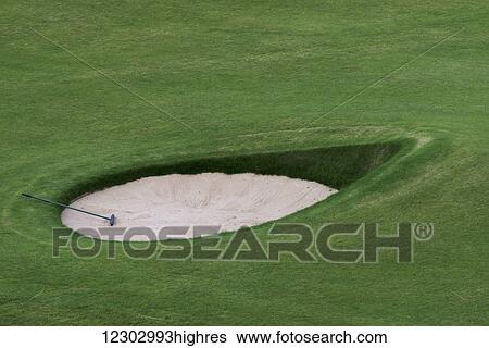 Stock Photograph - Golf club in a sand trap on a golf course; Maidens, Ayrshire, Scotland. Fotosearch