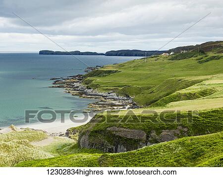 Stock Photograph - Grass slopes along the rugged coastline; Scotland. Fotosearch