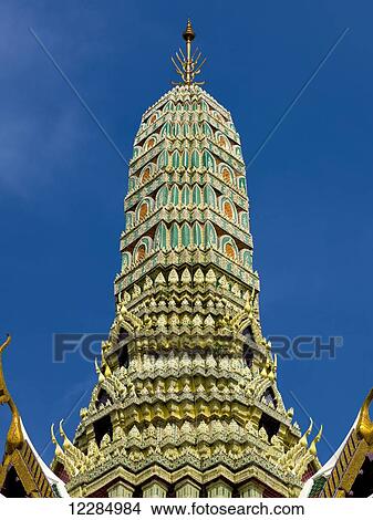 Green and gold tower against a blue sky, Temple of the Emerald Buddha (Wat Phra Kaew); Bangkok, Thailand View Large Photo Image Picture - Green and gold tower against a blue sky, Temple of the Emerald Buddha (Wat Phra Kaew); Bangkok, Thailand. Fotosearch