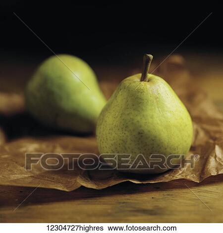Green pears sitting on brown parchment paper on a wooden counter; Toronto, Ontario, Canada View Large Photo Image Stock Photograph - Green pears sitting on brown parchment paper on a wooden counter; Toronto, Ontario, Canada. Fotosearch