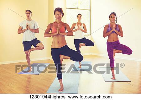 Stock Photograph - Group of People Relaxing and Doing Yoga. Wellness and Healthy Lifestyle.. Fotosearch