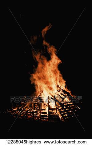 Stock Photograph - Guy Fawkes Night, bonfire burning at night; London, England. Fotosearch