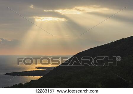 Stock Photo - Hand of Gold Lighting over pali (cliff) on Kealakekua Bay; Kona, Island of Hawaii, Hawaii, United States of America. Fotosearch