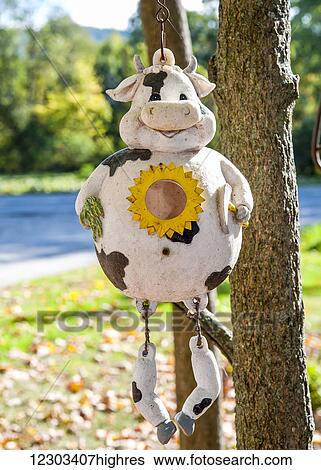 Stock Photograph - Happy cow hanging from a tree on Herb Hodges farm; Fairlee, Vermont, United States of America. Fotosearch