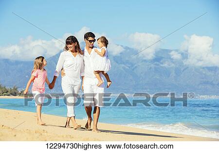 Stock Photograph - Happy Family Having Fun on Beautiful Sunny Beach. Fotosearch