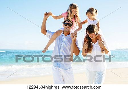 Happy family having fun on the beach View Large Photo Image Stock Photograph - Happy family having fun on the beach. Fotosearch