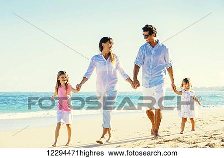 Stock Photograph - Happy Family Having Fun Walking on Tropical Beach. Fotosearch