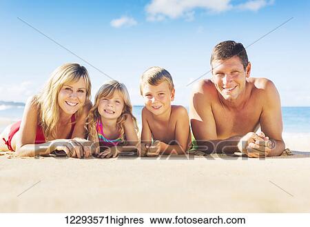 Stock Photograph - Happy Family of Four on Tropical Beach, Summer Lifestyle. Fotosearch