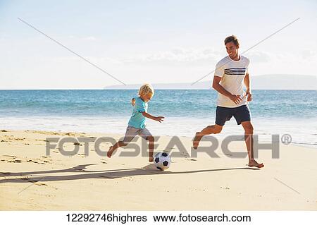 Happy Father and Son Having Fun Playing Soccer on the Beach View Large Photo Image Stock Photograph - Happy Father and Son Having Fun Playing Soccer on the Beach. Fotosearch