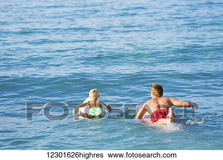 Happy Father and Young Son Going Surfing Together View Large Photo Image Stock Photograph - Happy Father and Young Son Going Surfing Together. Fotosearch