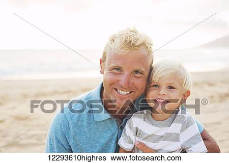 Stock Photograph - Happy loving father and son at the beach. Fotosearch