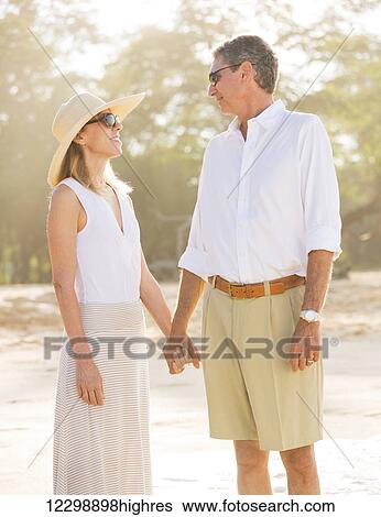 Happy Romantic Couple Walking on the Beach View Large Photo Image Stock Photograph - Happy Romantic Couple Walking on the Beach. Fotosearch