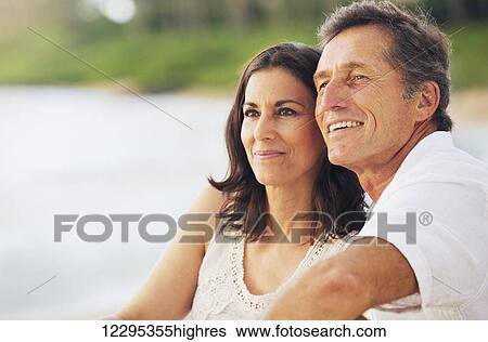 Happy Romantic Mature Couple Enjoying Sunset on the Beach View Large Photo Image Stock Photograph - Happy Romantic Mature Couple Enjoying Sunset on the Beach. Fotosearch