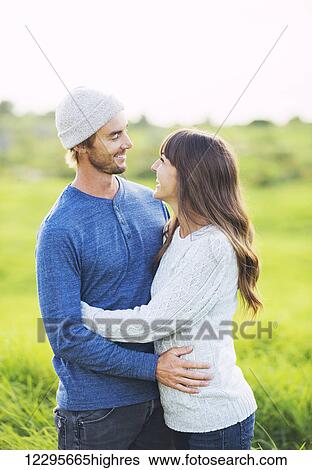 Happy Young Couple Having Fun Outdoors. Romantic Couple Kissing in Love. View Large Photo Image Stock Photograph - Happy Young Couple Having Fun Outdoors. Romantic Couple Kissing in Love.. Fotosearch