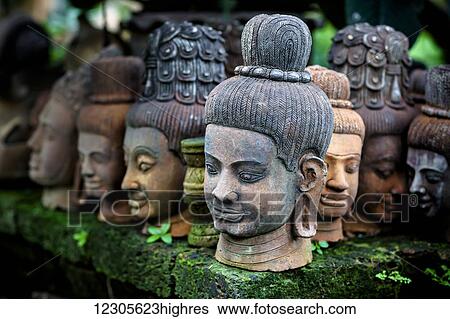 Stock Photograph - Heads of statues of Buddha are stacked in a terra-cotta factory; Chiang Mai, Thailand. Fotosearch