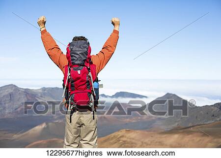 Hiker with backpack enjoying view from top of a mountain. Celebrating victory making it to the summit. Success and achievement concept. View Large Photo Image Stock Photograph - Hiker with backpack enjoying view from top of a mountain. Celebrating victory making it to the summit. Success and achievement concept.. Fotosearch
