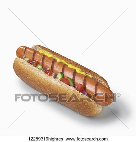 Stock Photograph - Hot dog with mustard and vegetables on a white background; Toronto, Ontario, Canada. Fotosearch