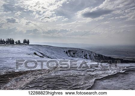 Stock Photograph - Hot springs and travertines, terraces of carbonate minerals left by the flowing water; Pamukkale, Turkey. Fotosearch