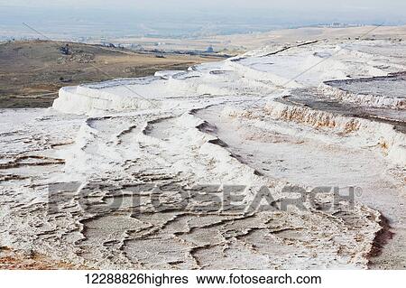 Hot springs and travertines, terraces of carbonate minerals left by the flowing water; Pamukkale, Turkey View Large Photo Image Stock Photograph - Hot springs and travertines, terraces of carbonate minerals left by the flowing water; Pamukkale, Turkey. Fotosearch