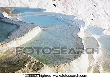 Hot springs and travertines, terraces of carbonate minerals left by the flowing water; Pamukkale, Turkey View Large Photo Image Stock Photograph - Hot springs and travertines, terraces of carbonate minerals left by the flowing water; Pamukkale, Turkey. Fotosearch
