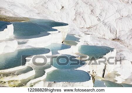 Hot springs and travertines, terraces of carbonate minerals left by the flowing water; Pamukkale, Turkey View Large Photo Image Stock Photograph - Hot springs and travertines, terraces of carbonate minerals left by the flowing water; Pamukkale, Turkey. Fotosearch