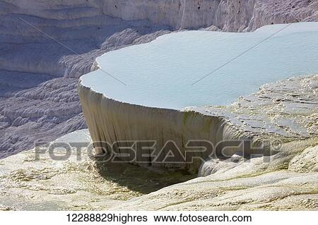Hot springs and travertines, terraces of carbonate minerals left by the flowing water; Pamukkale, Turkey View Large Photo Image Stock Photograph - Hot springs and travertines, terraces of carbonate minerals left by the flowing water; Pamukkale, Turkey. Fotosearch