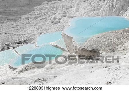 Stock Photograph - Hot springs and travertines, terraces of carbonate minerals left by the flowing water; Pamukkale, Turkey. Fotosearch