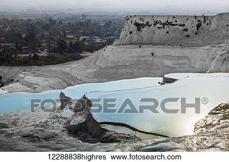 Stock Photograph - Hot springs and travertines, terraces of carbonate minerals left by the flowing water; Pamukkale, Turkey. Fotosearch